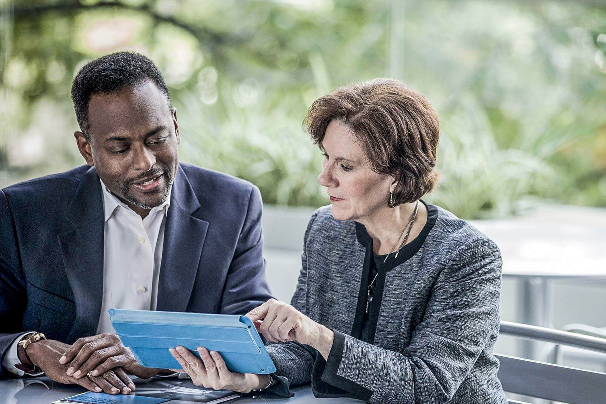 Man and Woman discussing over mobile device